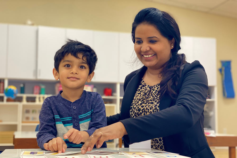 Montessori teacher working with a preschool kindergarten student