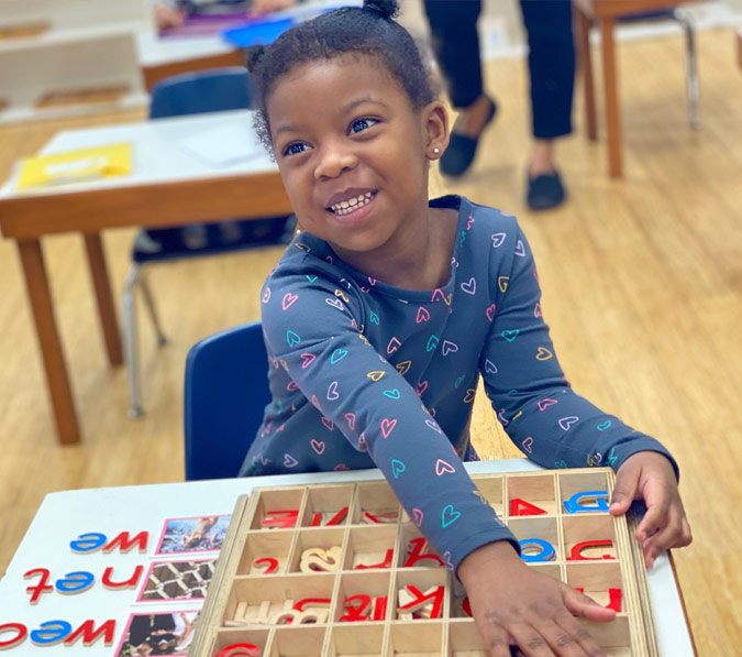 Toddlers learning with Montessori materials