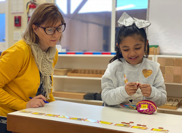 Montessori School of San Leandro teacher working with daycare child